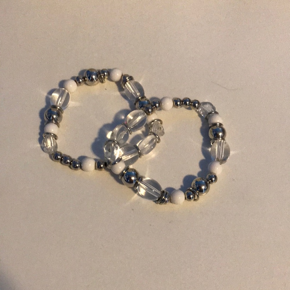2 silver and white bracelets